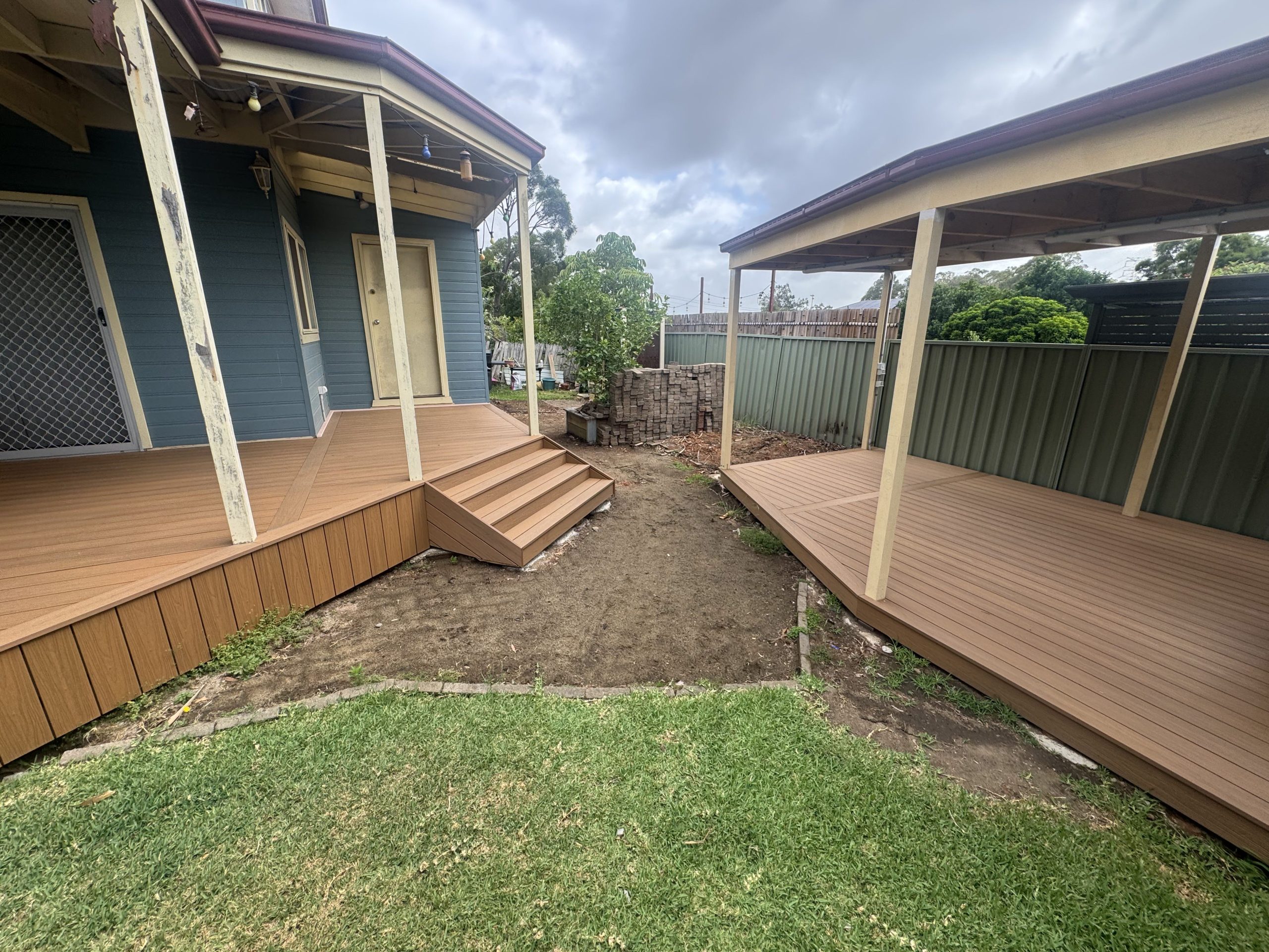 Backyard travertine paving and timber deck — before