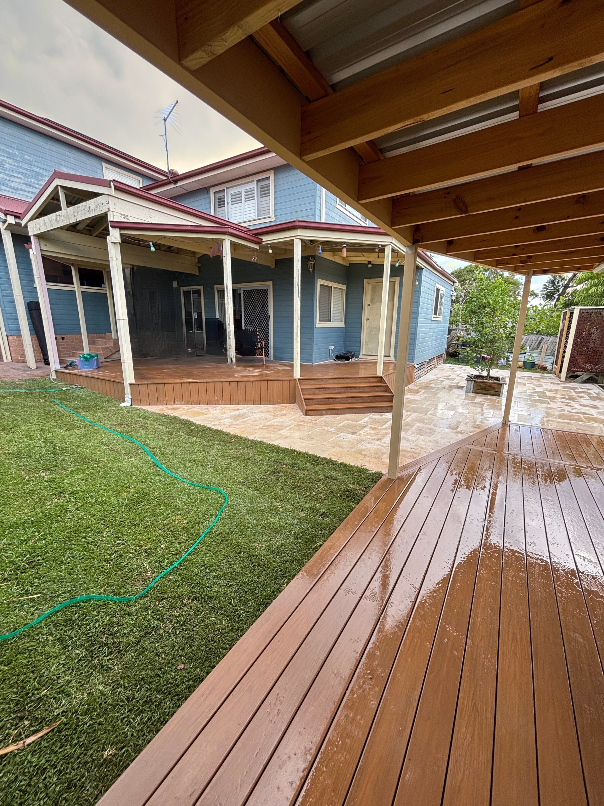 Backyard travertine paving and timber deck — after